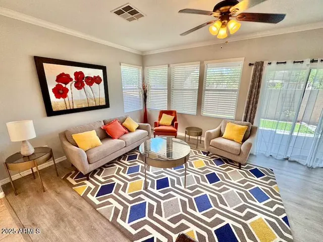 a living room with patio chairs and a table
