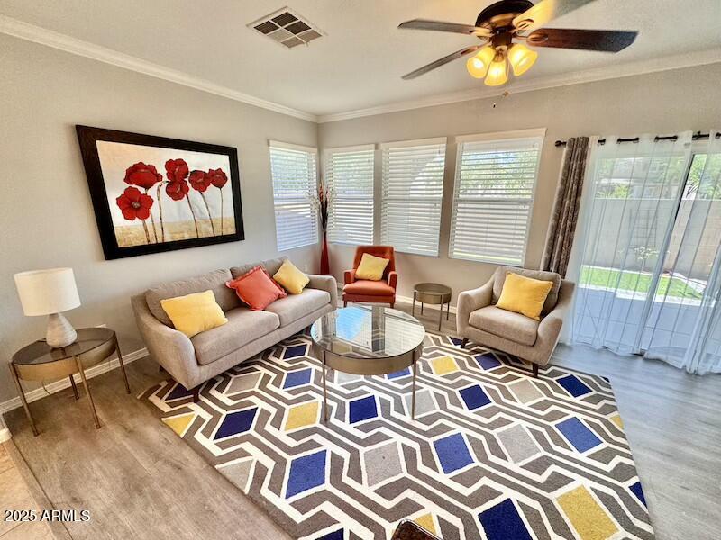 a living room with patio chairs and a table