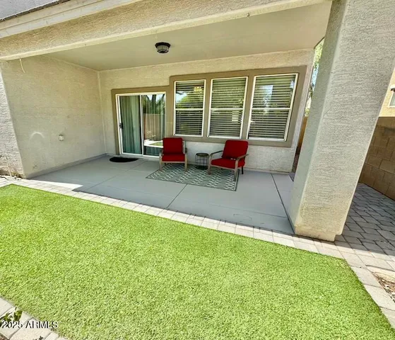 a backyard of a house with outdoor seating
