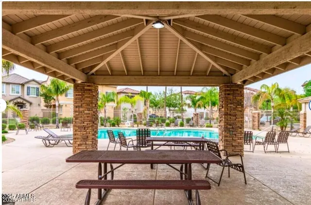a patio with water glass top table and chairs