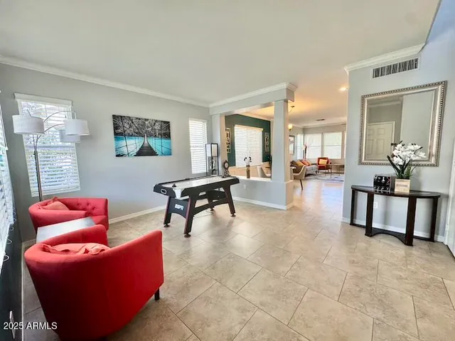 a living room with furniture and a dining table