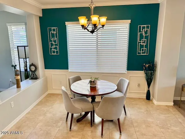 a view of a dining room with furniture and chandelier