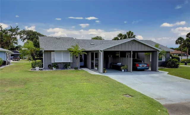 a view of a house with a yard and sitting area