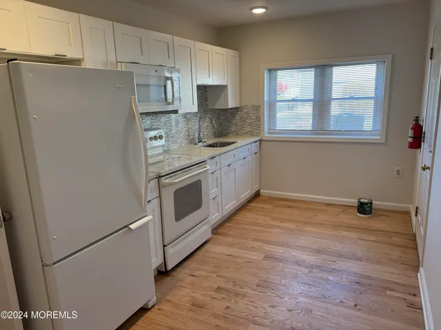 a kitchen with stainless steel appliances a refrigerator sink and cabinets
