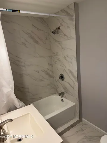 a bathroom with a bathtub and shower