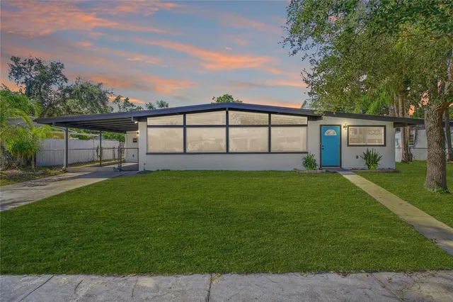 a view of a house with a yard and a garden
