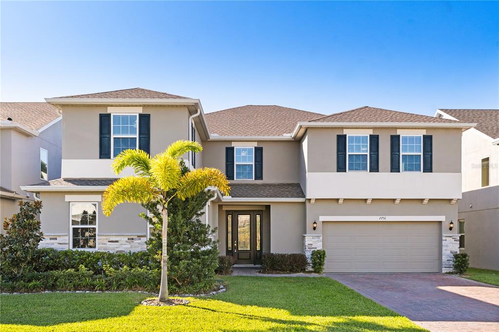 7757 Marsala Street Clermont, FL 34714 - Photo 1 of 75 a front view of a house with garden