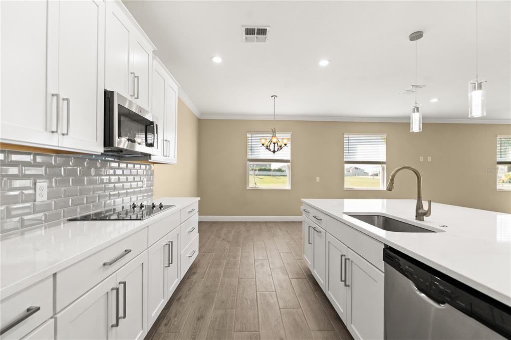 7757 Marsala Street Clermont, FL 34714 - Photo 13 of 75 a kitchen with sink stove and cabinets