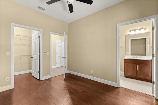 a bathroom with a double vanity sink a mirror and a bathtub