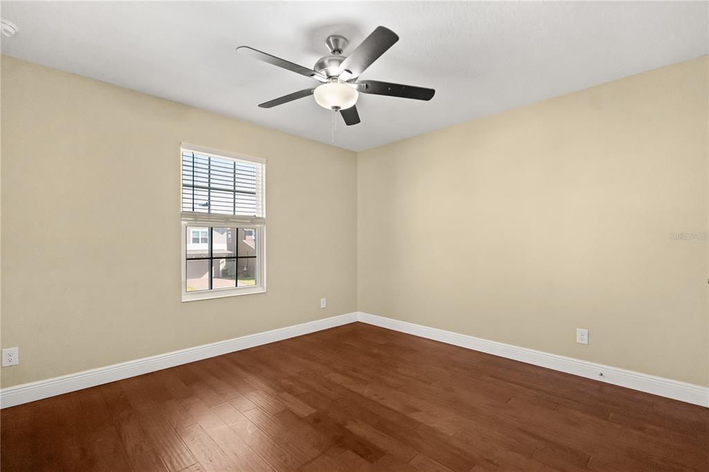 7757 Marsala Street Clermont, FL 34714 - Photo 21 of 75 an empty room with windows and ceiling fan