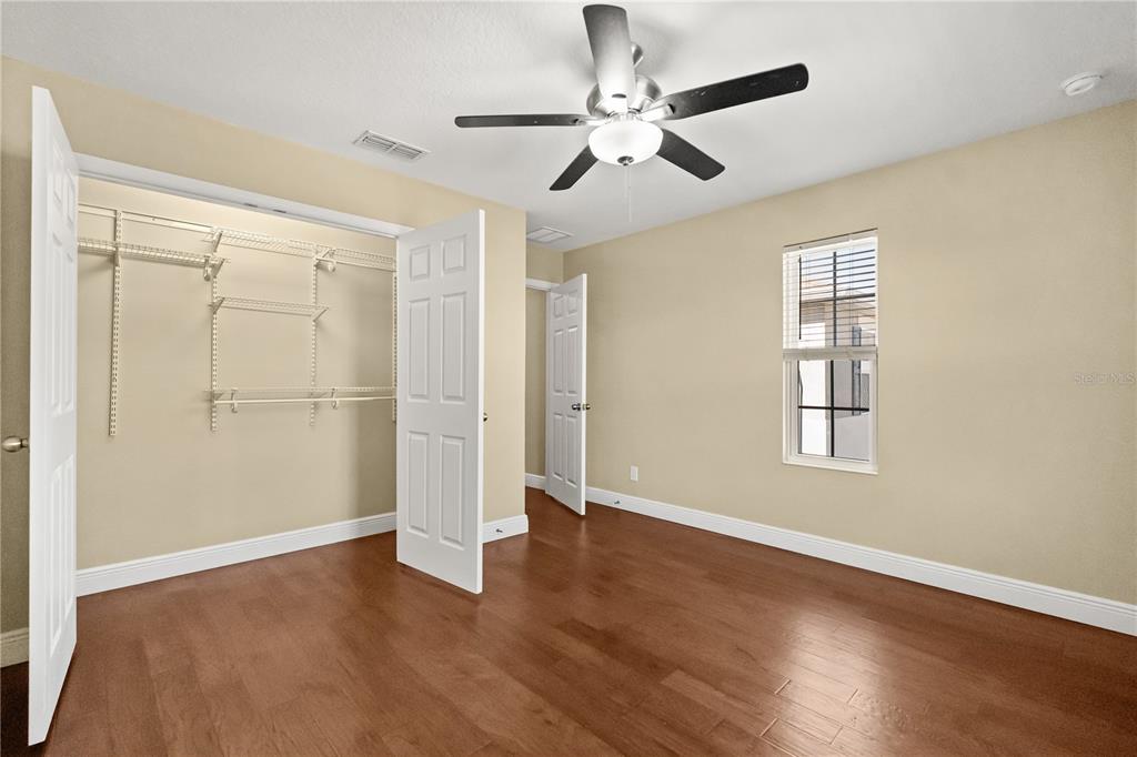 7757 Marsala Street Clermont, FL 34714 - Photo 22 of 75 a view of an empty room with wooden floor and a window