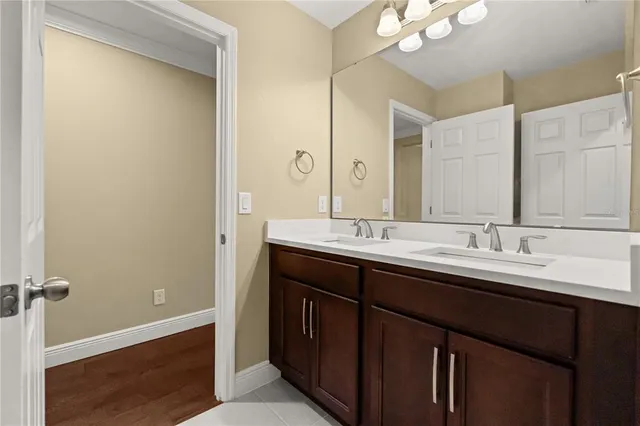 an empty room with wooden floor and ceiling fan