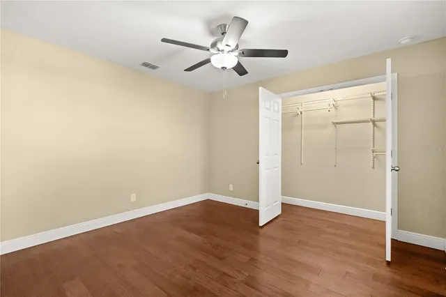 a view of empty room with wooden floor and fireplace