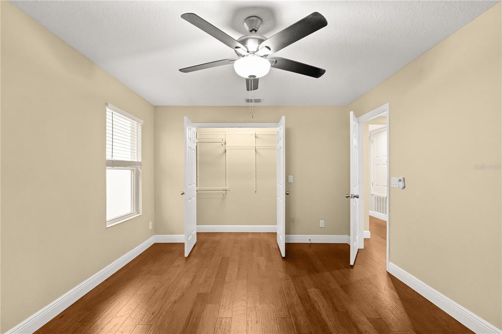 7757 Marsala Street Clermont, FL 34714 - Photo 33 of 75 a view of an empty room with window and wooden floor