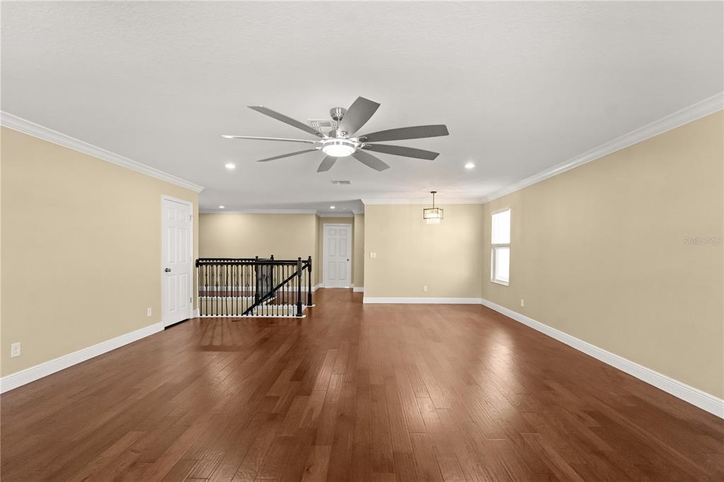 7757 Marsala Street Clermont, FL 34714 - Photo 40 of 75 a view of an empty room with wooden floor and a window