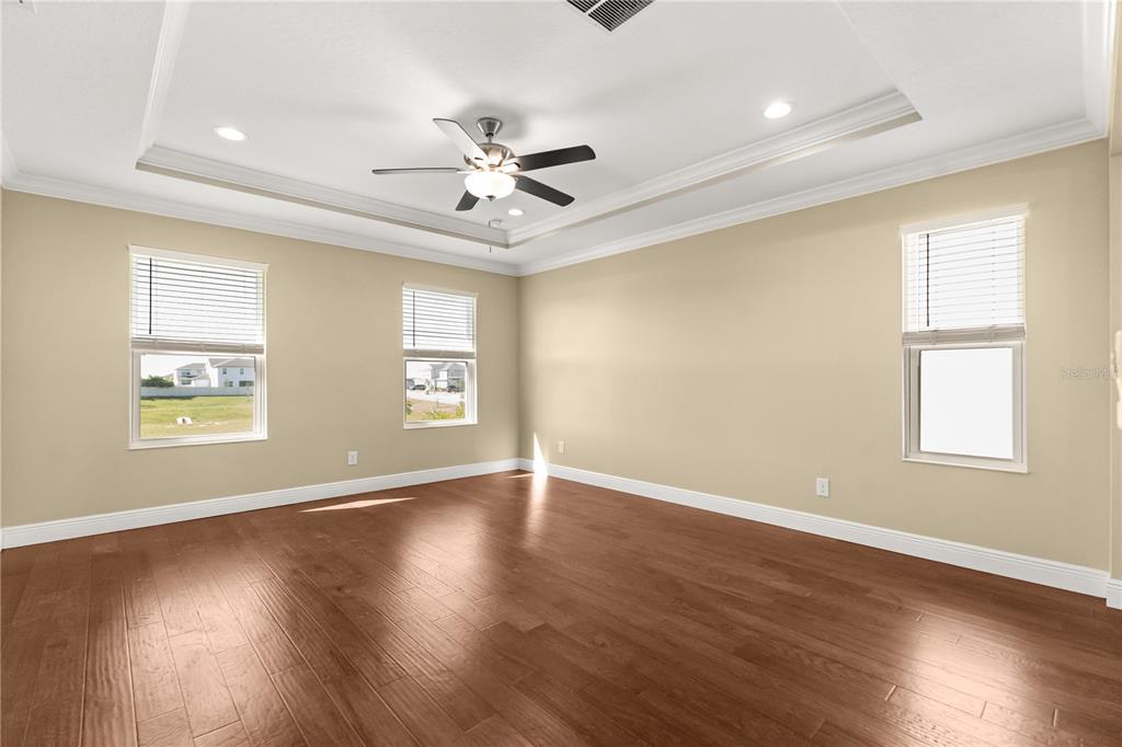 7757 Marsala Street Clermont, FL 34714 - Photo 47 of 75 a view of an empty room with wooden floor and a window