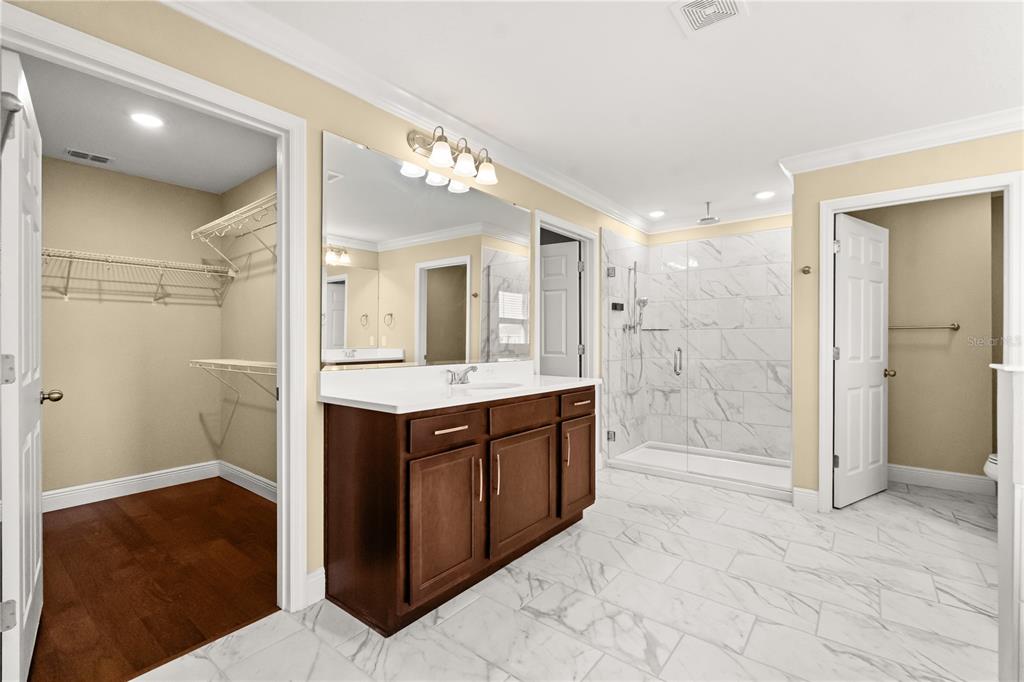 7757 Marsala Street Clermont, FL 34714 - Photo 50 of 75 a spacious bathroom with a shower sink and mirror