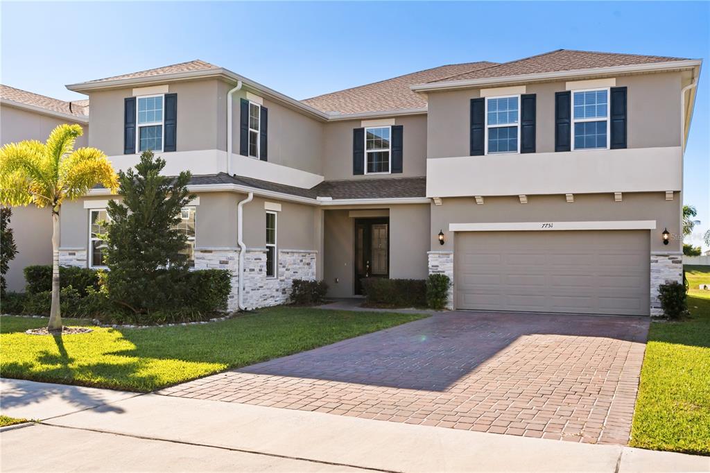 7757 Marsala Street Clermont, FL 34714 - Photo 5 of 75 a front view of a house with garden