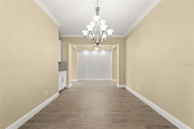a view of a kitchen with an empty space and a window