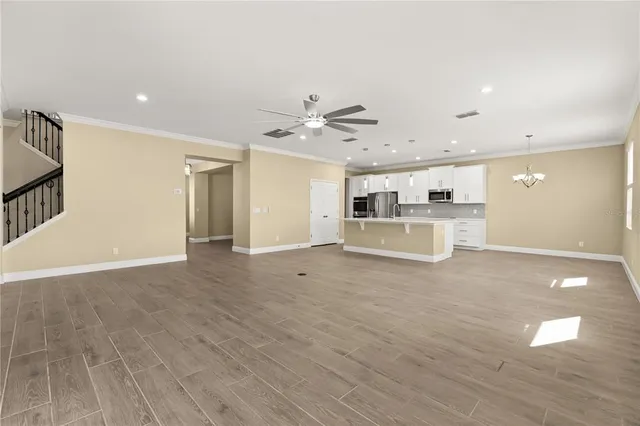 a large white kitchen with a large counter top appliances and cabinets