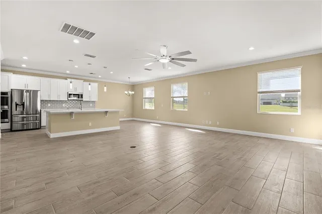 a kitchen with stainless steel appliances a sink stove and cabinets