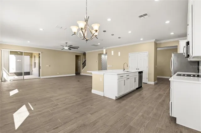 a kitchen with sink stove and cabinets
