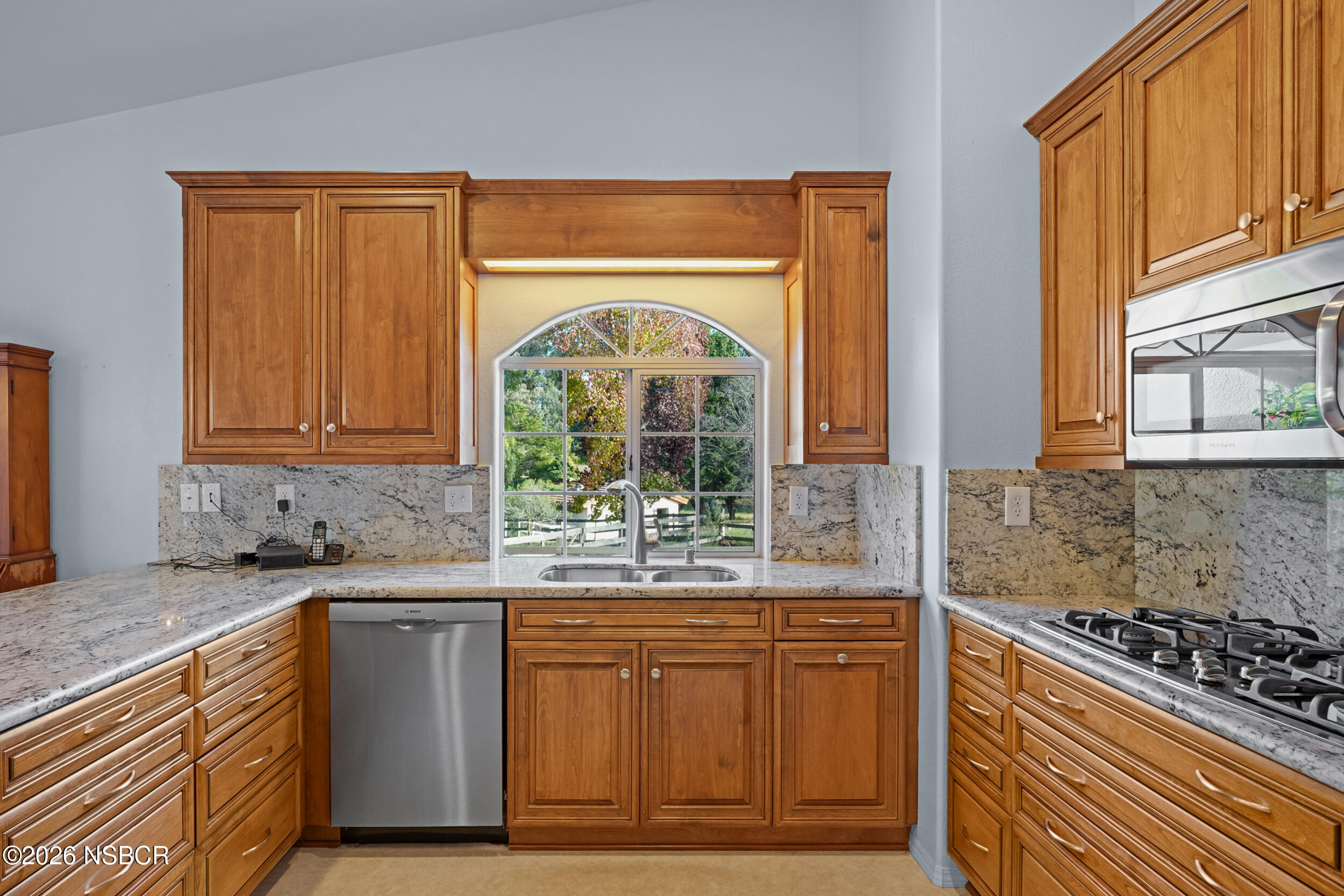 745 Inga Road Nipomo, CA 93444 - Photo 13 of 55 a kitchen with stainless steel appliances granite countertop a stove a sink and a granite counter tops with a large window