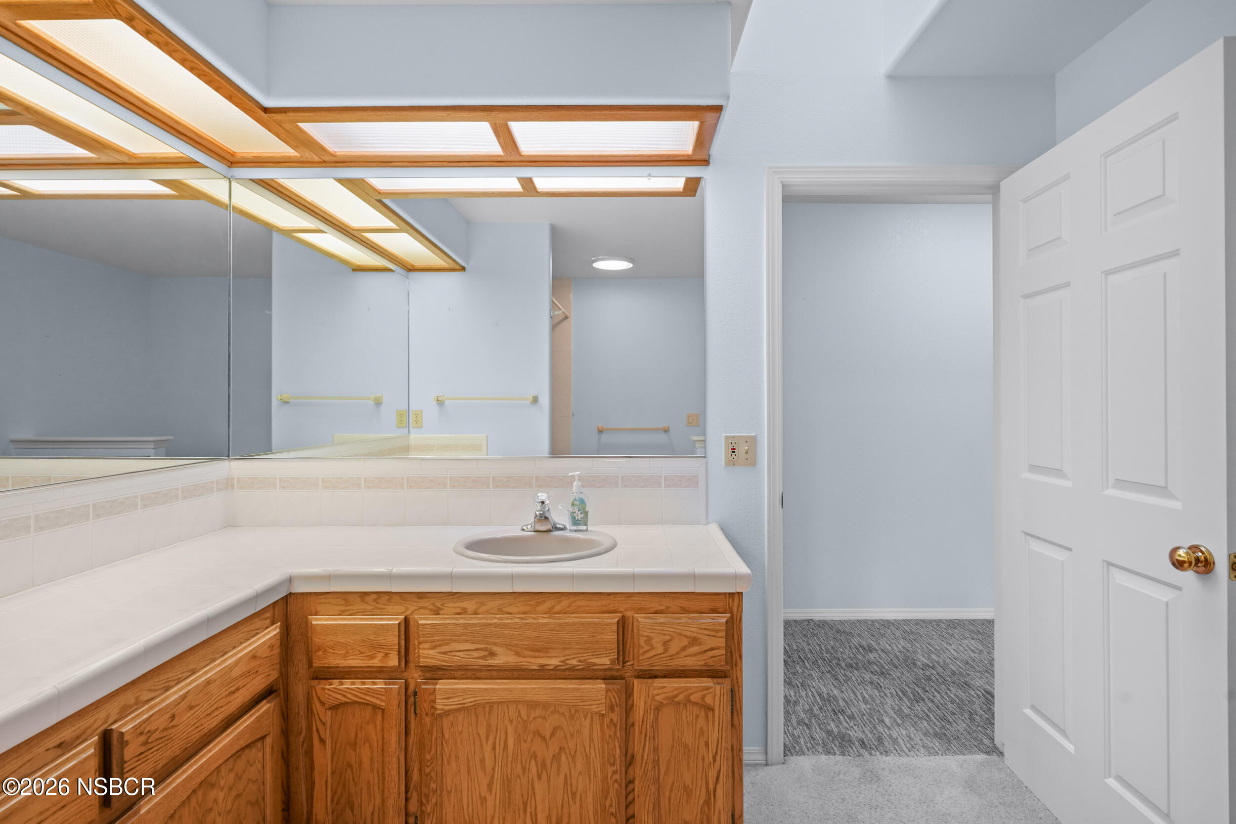 745 Inga Road Nipomo, CA 93444 - Photo 28 of 55 a bathroom with a sink and a mirror