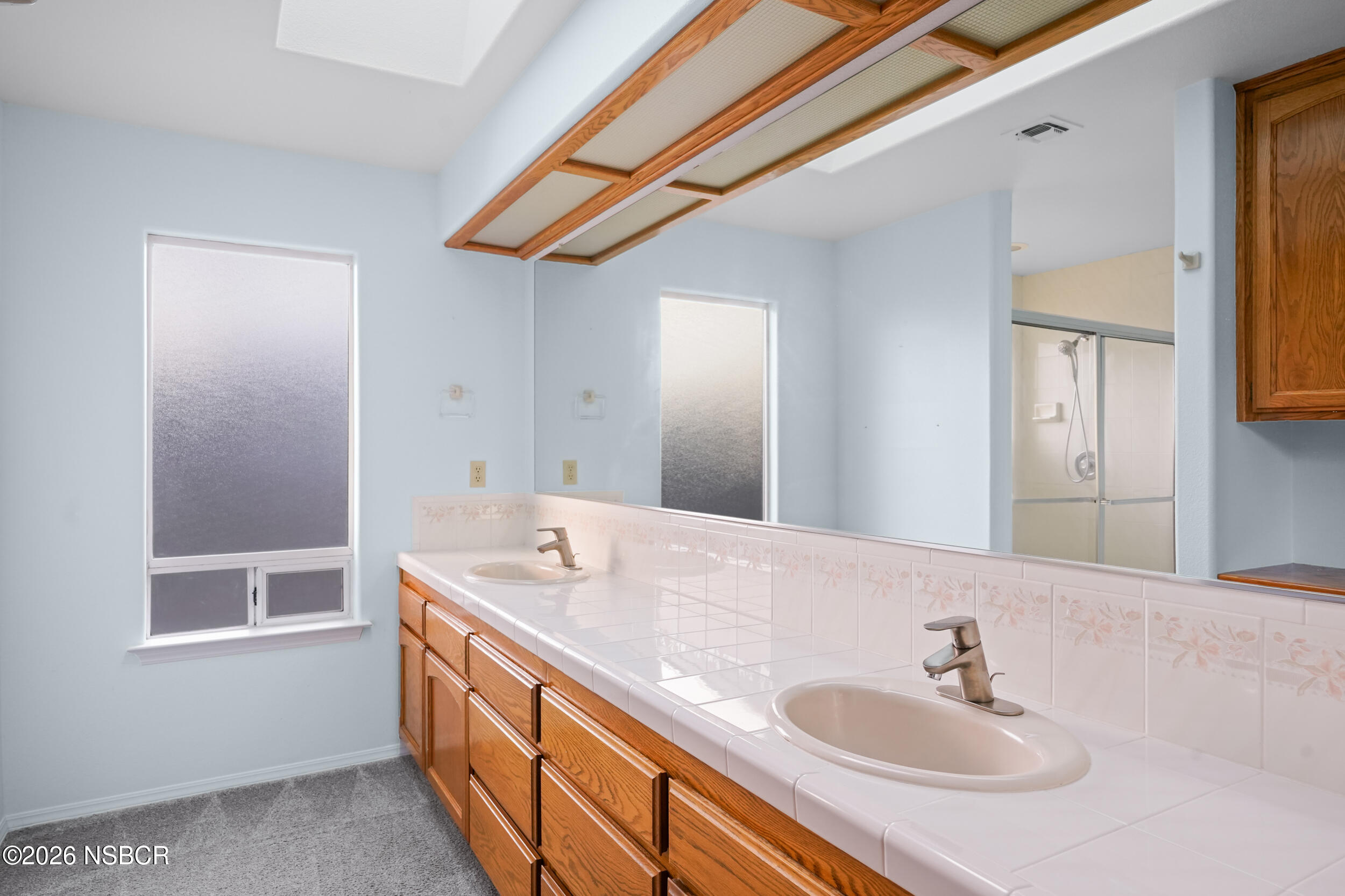 745 Inga Road Nipomo, CA 93444 - Photo 35 of 55 a bathroom with a granite countertop sink and a large mirror