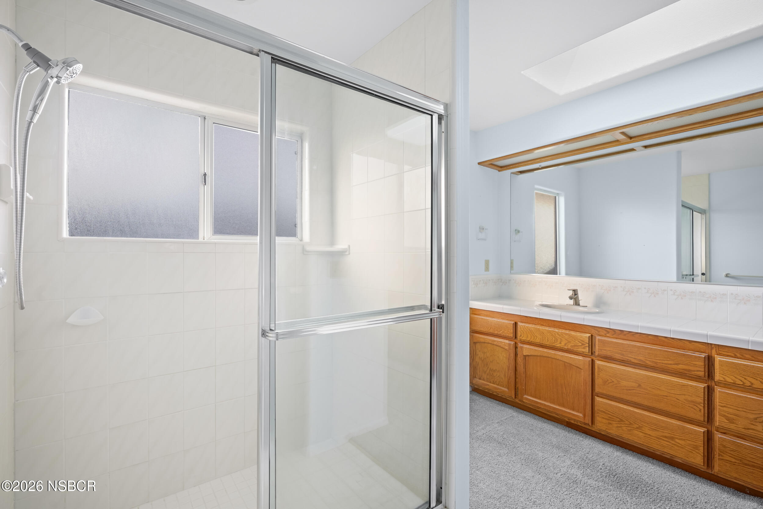 745 Inga Road Nipomo, CA 93444 - Photo 36 of 55 a bathroom with a double vanity sink and mirror