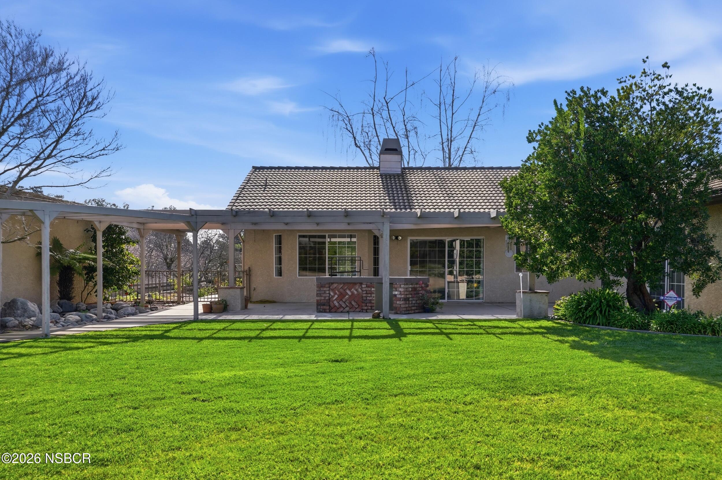 745 Inga Road Nipomo, CA 93444 - Photo 49 of 55 a front view of house with a garden and trees