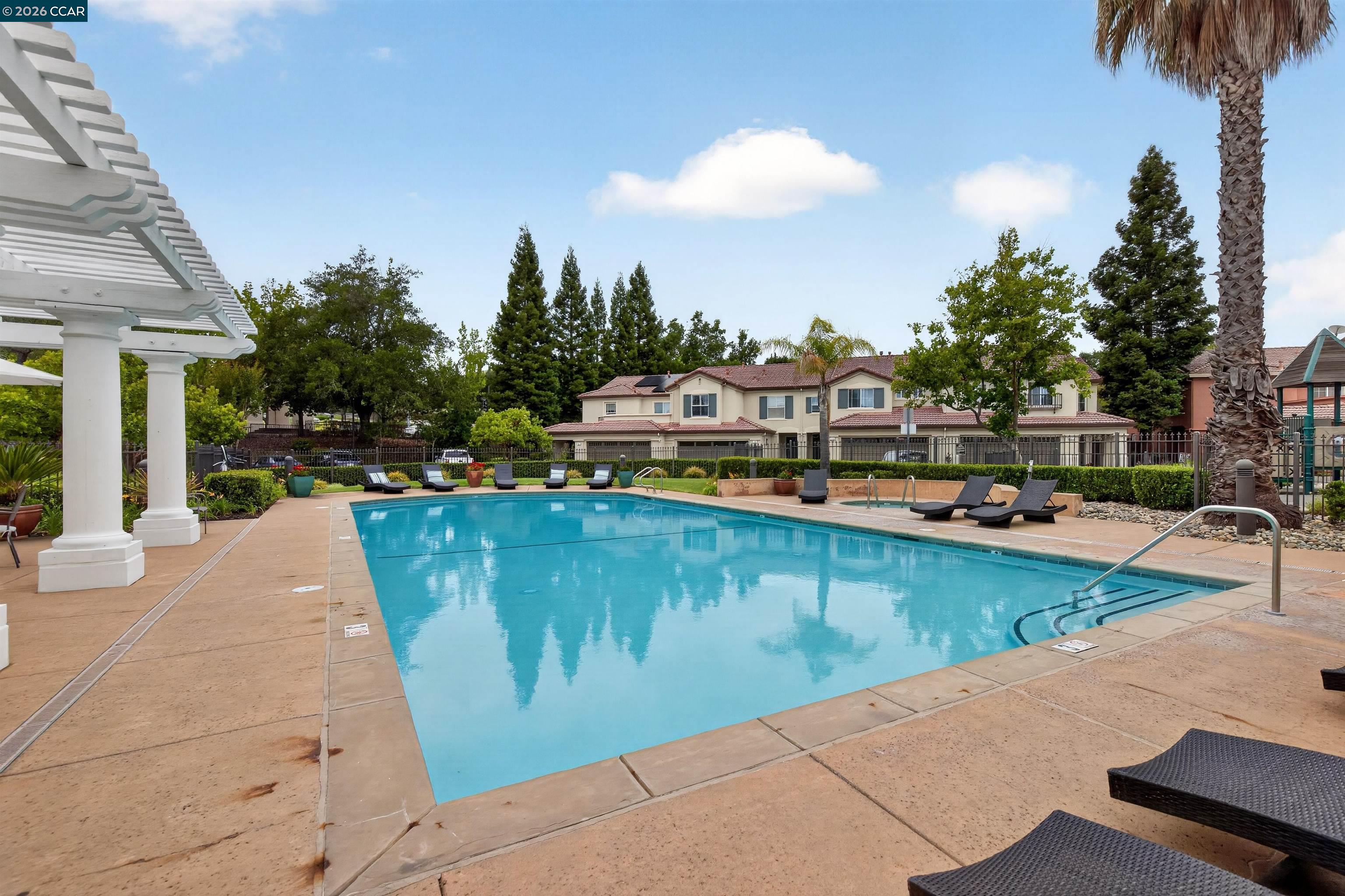 124 Coralflower Lane San Ramon, CA 94582 - Photo 37 of 47 a view of a swimming pool with a lounge chairs