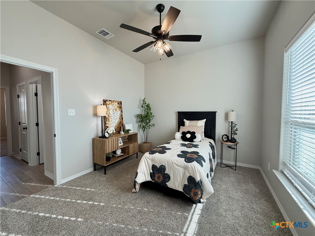 203 Lasso Loop Lorena, TX 76655 - Photo 16 of 37 a bed sitting in a bedroom next to a window