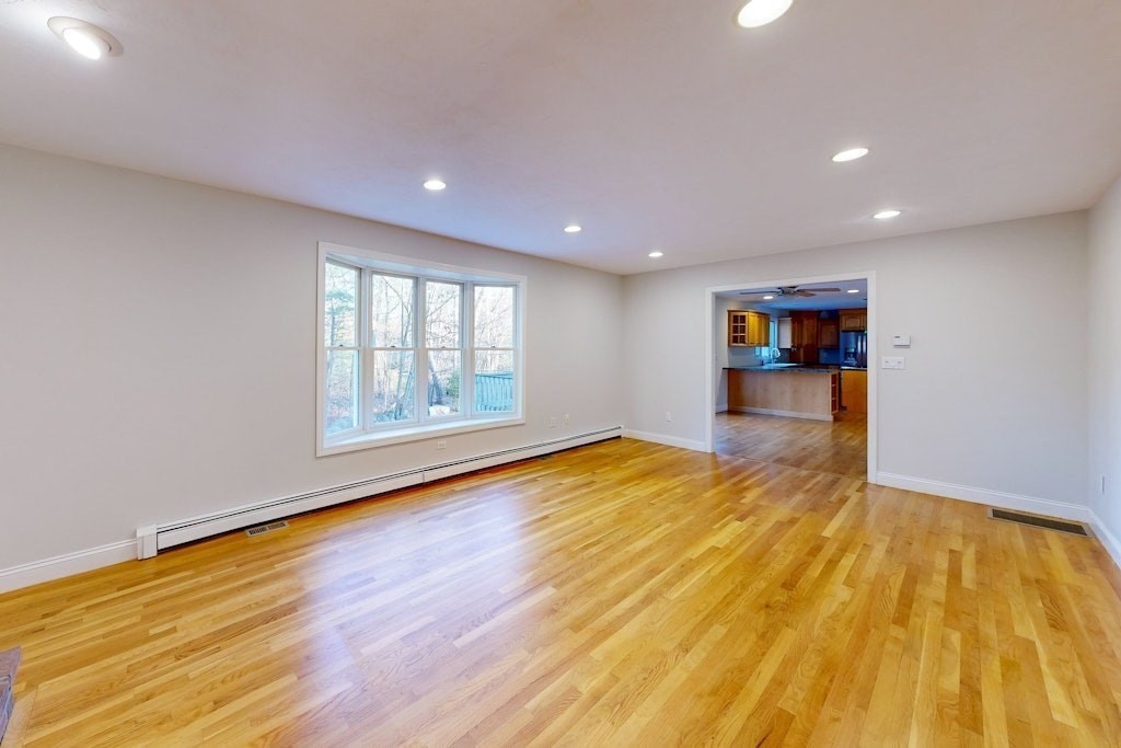 7 Delaney Drive Walpole, MA 02081 - Photo 11 of 35 a view of empty room with wooden floor and fan