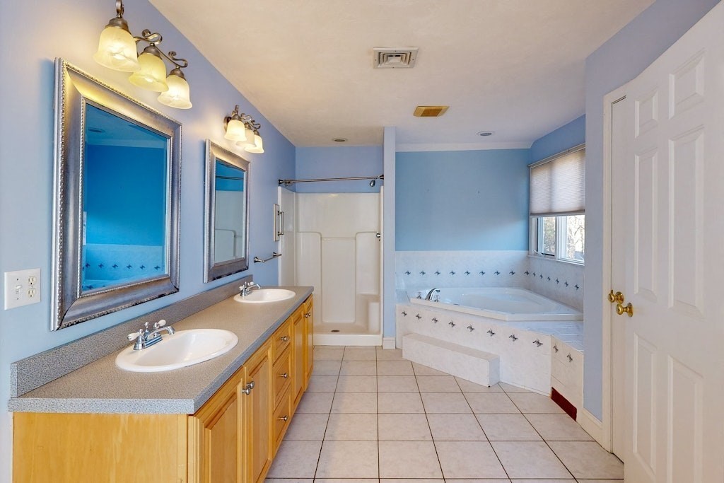 7 Delaney Drive Walpole, MA 02081 - Photo 16 of 35 a bathroom with a sink double vanity granite tub shower and a mirror