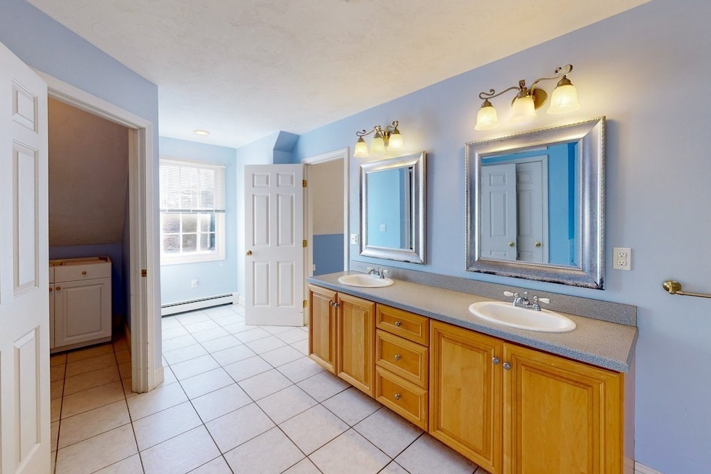 7 Delaney Drive Walpole, MA 02081 - Photo 17 of 35 a spacious bathroom with a double vanity sink a mirror and a shower