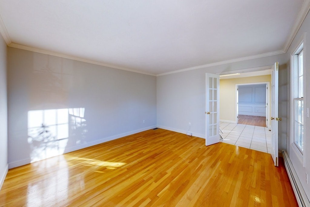 7 Delaney Drive Walpole, MA 02081 - Photo 5 of 35 a bedroom with a bed and wooden floor