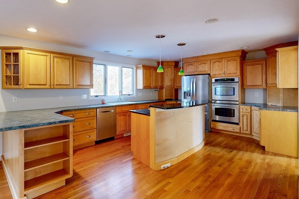 7 Delaney Drive Walpole, MA 02081 - Photo 6 of 35 a kitchen with stainless steel appliances wooden floors and a window