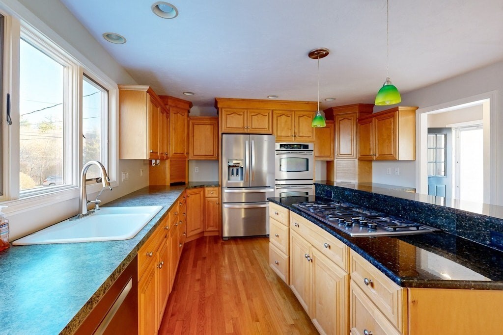 7 Delaney Drive Walpole, MA 02081 - Photo 7 of 35 a kitchen with stainless steel appliances a stove a sink and a refrigerator