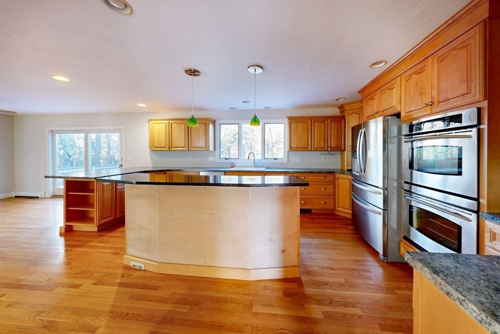 7 Delaney Drive Walpole, MA 02081 - Photo 8 of 35 a large kitchen with stainless steel appliances granite countertop a large counter top and a stove