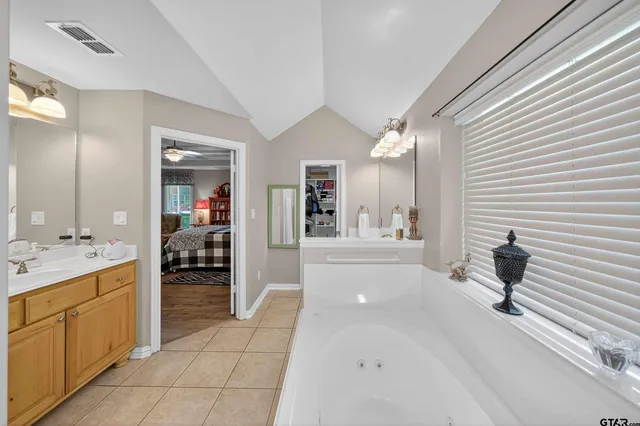 a bedroom with two beds and window