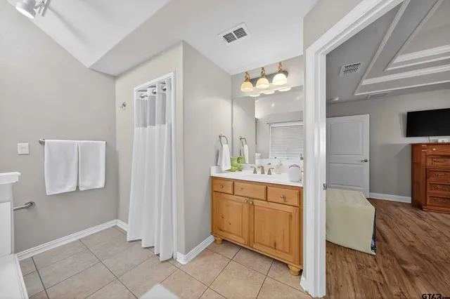 a bedroom with two beds and a chandelier