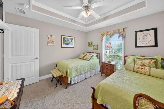 a bed room with a bed and painting on the wall