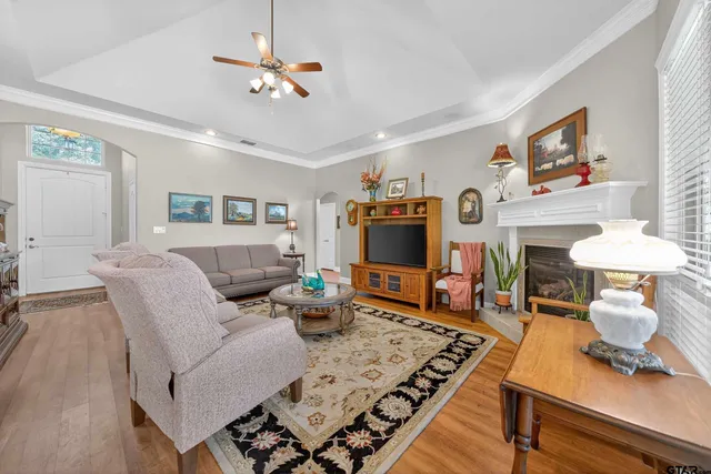 a living room with furniture a fireplace and a flat screen tv