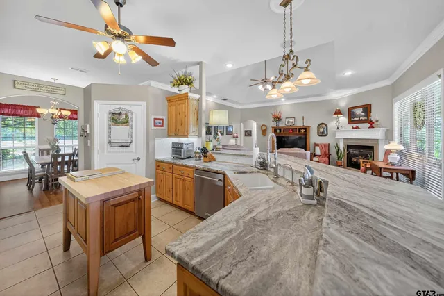 a large kitchen with cabinets table and chairs