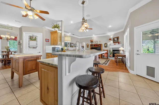 a view of a dining room and kitchen with a table chairs and chandelier