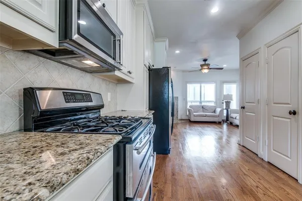 a kitchen with stove and cabinets