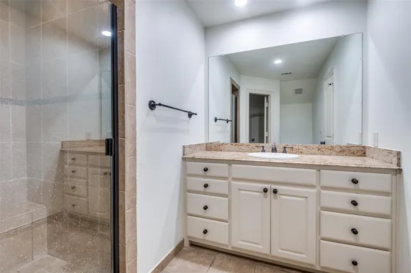 a bathroom with a double vanity sink and mirror
