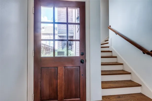 a view of entryway with wooden floor and windows