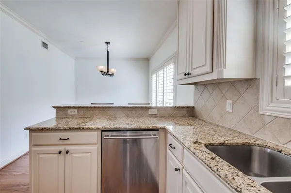 a kitchen with granite countertop a sink dishwasher and granite counter tops